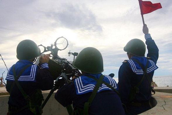 Vietnamese sailors train with a 12.7mm machine gun during a naval drill Monday. 