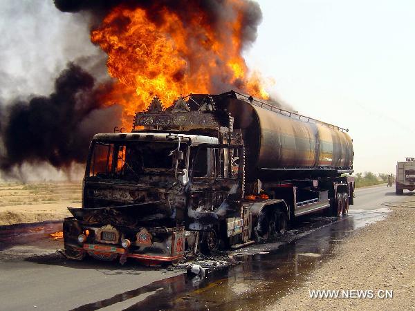 Fire rages from a NATO oil tanker near southwest Pakistan's Sibi on June 15, 2011. At least one driver was injured following an attack on two NATO oil tankers by unknown gunmen. [Iqbal Hussain/Xinhua] 
