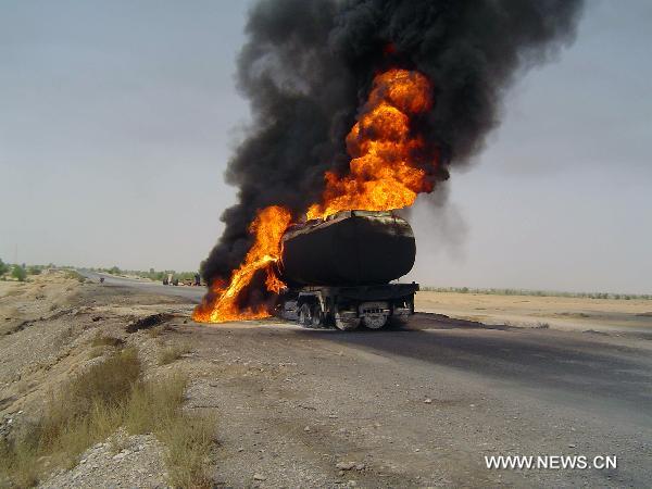 Fire rages from a NATO oil tanker near southwest Pakistan's Sibi on June 15, 2011. At least one driver was injured following an attack on two NATO oil tankers by unknown gunmen. [Iqbal Hussain/Xinhua] 