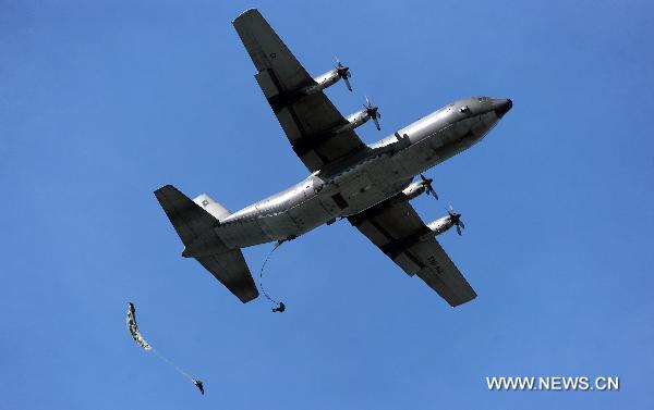 Soldiers of special forces from China's People's Liberation Army (PLA) and Indonesia's National Armed Forces (TNI) parachute from a plane during a united training in Bandung, Indonesia, June 17, 2011. The united training, with a code name of 'Sharp Knife 2011', closed on Friday. It was the first one between PLA and TNI in the history. [Jiang Fan/Xinhua]