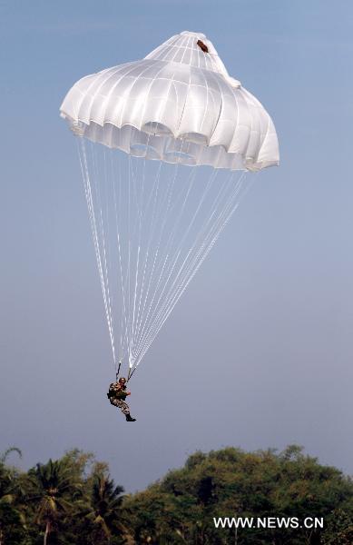 A soldiers parachute from a plane during a united training for special forces from China's People's Liberation Army (PLA) and Indonesia's National Armed Forces (TNI) in Bandung, Indonesia, June 17, 2011. The united training, with a code name of 'Sharp Knife 2011', closed on Friday. It was the first one between PLA and TNI in the history. [Jiang Fan/Xinhua]