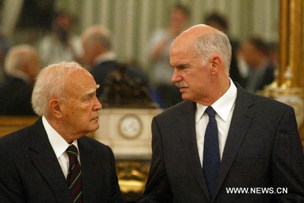 Greek President Karolos Papoulias (L) and Prime Minister George Papandreou attend the new government inauguaration ceremony in Athens, Greece, June 17, 2011. Greece's new government lead by Prime Minister George Papandreou was sworn in Friday, shortly after a broad reshuffle made 20 months since the socialist ruling party took office amidst an acute debt crisis. [Marios Lolos/Xinhua]