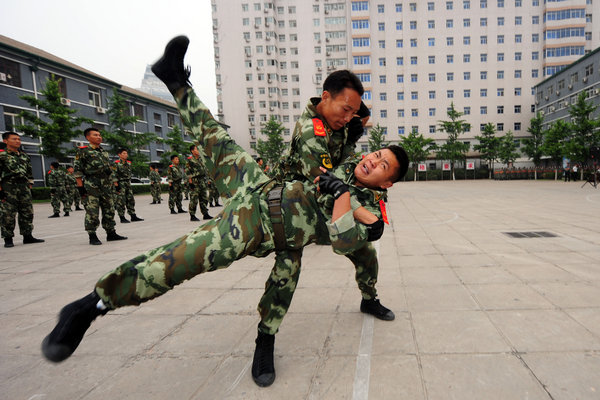 Members of the Chinese armed police show skills to control terrorists during an anti-terrorism demonstration in Beijing to celebrate the 90th anniversary of Communist Party of China, June 16, 2011. [Photo/CFP]