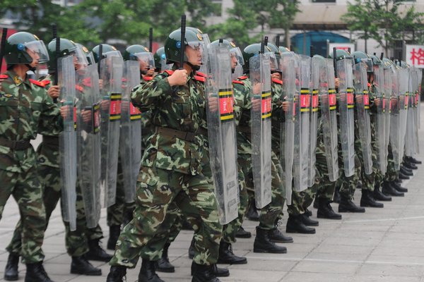 Chinese armed police use shields to control simulated mobs during a demonstration in Beijing to celebrate the 90th anniversary of Communist Party of China, June 16, 2011. [Photo/CFP]