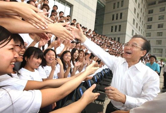 Chinese Premier Wen Jiabao shakes hands with graduates at Beijing Normal University in Beijing, June 17, 2011. China's Ministry of Education waved tuition fees for students who majored in education at six universities, which have been under direct administration of the ministry since the autumn semester in 2007. [Photo/Xinhua]