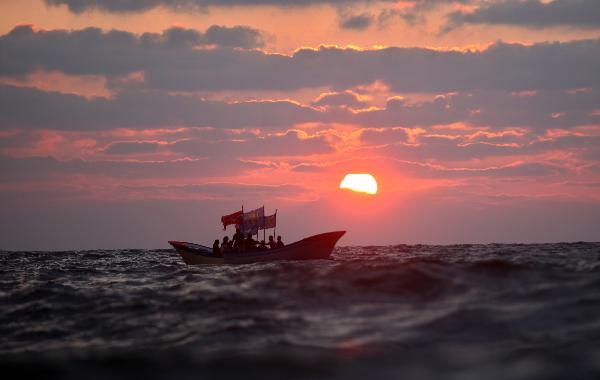 Palestinians ride on a boat off Gaza sea beach during a summer hot day, June 18, 2011. [Xinhua/Yasser Qudih]