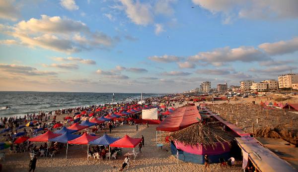 Palestinians enjoy their times on Gaza sea beach during a summer hot day, June 18, 2011. [Xinhua/Yasser Qudih]