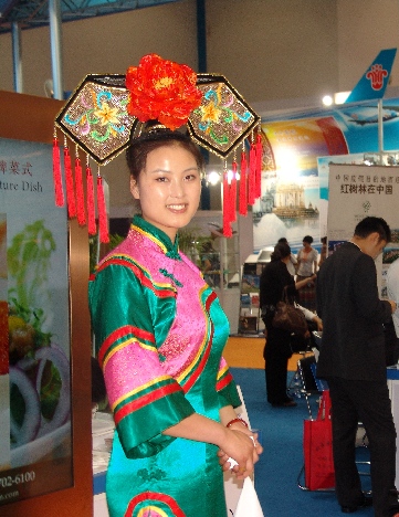 Headdress—A woman dressed in a traditional southern costume (!! I don't know if that's true!!_ invites passersby to China Southern's booth.