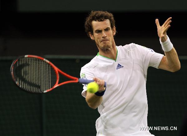 Andy Murray of Britain returns the ball during his first round match against Daniel Gimeno-Traver of Spain at the 2011 Wimbledon tennis Championships in London, Britain, June 20, 2011. Andy Murray won 3-1. (Xinhua/Tang Shi) 