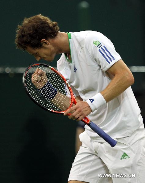 Andy Murray of Britain reacts during his first round match against Daniel Gimeno-Traver of Spain at the 2011 Wimbledon tennis Championships in London, Britain, June 20, 2011. Andy Murray won 3-1. (Xinhua/Tang Shi) 