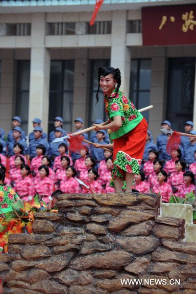 An actress performs on stage during a songfest to celebrate the 90th anniversary of the founding of the Communist Party of China (CPC) in Wuxiang, north China's Shanxi Province, June 20, 2011. (Xinhua/Fan Minda) (dy) 