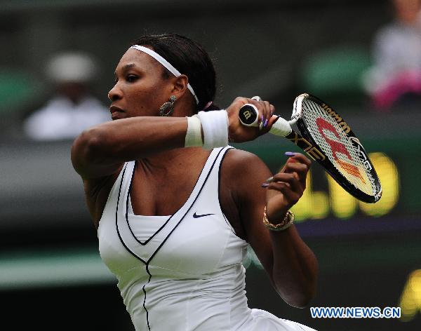 Serena Williams of the United States returns a shot during her first round match of women's singles against Aravane Rezai of France in 2011 Wimbledon tennis Championships in London, Britain, June 21, 2011. Williams won 2-1. (Xinhua/Zeng Yi)