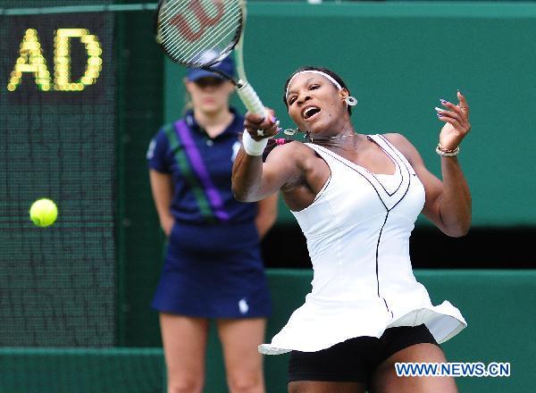 Serena Williams of the United States returns a shot during her first round match of women's singles against Aravane Rezai of France in 2011 Wimbledon tennis Championships in London, Britain, June 21, 2011. Williams won 2-1. (Xinhua/Zeng Yi)