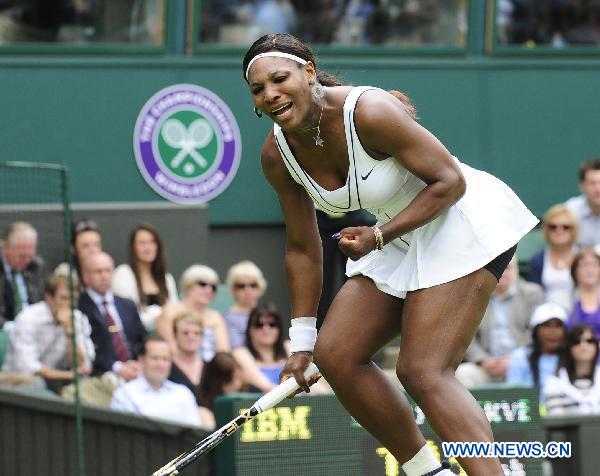 Serena Williams of the United States celebrates during her first round match of women's singles against Aravane Rezai of France in 2011 Wimbledon tennis Championships in London, Britain, June 21, 2011. Williams won 2-1. (Xinhua/Zeng Yi)