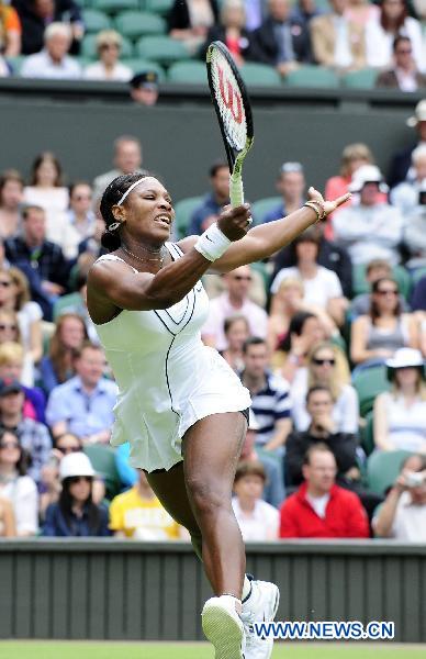 Serena Williams of the United States returns a shot during her first round match of women's singles against Aravane Rezai of France in 2011 Wimbledon tennis Championships in London, Britain, June 21, 2011. Williams won 2-1. (Xinhua/Zeng Yi)