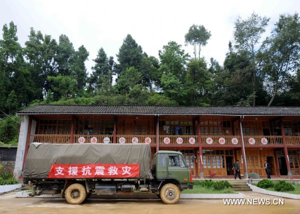 A truck carrying relief goods arrives at a primary school after an earthquake in Tengchong County, southwest China's Yunnan Province, June 21, 2011. The 5.2-magnitude earthquake that hit Tengchong on Monday has left six people injured and caused significant economic losses, the Ministry of Civil Affairs said Tuesday. As of 3 p.m. Tuesday, the quake had affected 22,000 local residents and led to the emergency relocation of 2,168 people. The local government has allocated 7 million yuan to set up a disaster relief fund, as well as sent hundreds of tents, quilts and articles of clothing to the quake zone, according to the ministry. (Xinhua/Yang Zongyou) (hdt) 