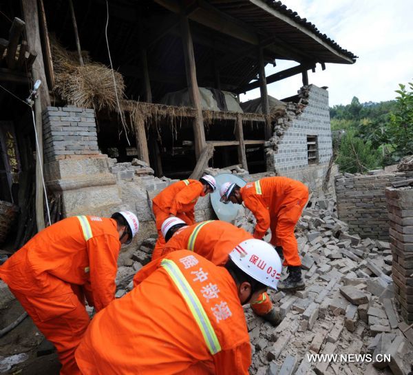 Rescuers clear the ruins caused by an earthquake in Tengchong County, southwest China's Yunnan Province, June 21, 2011. The 5.2-magnitude earthquake that hit Tengchong on Monday has left six people injured and caused significant economic losses, the Ministry of Civil Affairs said Tuesday. As of 3 p.m. Tuesday, the quake had affected 22,000 local residents and led to the emergency relocation of 2,168 people. The local government has allocated 7 million yuan to set up a disaster relief fund, as well as sent hundreds of tents, quilts and articles of clothing to the quake zone, according to the ministry. (Xinhua/Yang Zongyou) (hdt) 