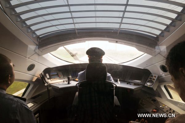 A driver operates a bullet train on the Beijing-Shanghai high-speed railway in Jinan, capital of east China's Shandong Province, June 21, 2011. Media reporters experienced a trial operation on the Beijing-Shanghai high-speed railway on Tuesday. It takes a 300-kph bullet train one hour and 32 minutes from Jinan West Railway Station to Beijing South Railway Station, 2 hours shorter than the current high-speed trains. (Xinhua/Zhu Zheng) (zgp) 