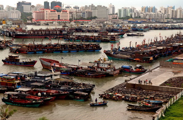 Fishing boats berth in a harbor in Haikou, Hainan province, June 22, 2011, as tropical storm Haima approaches.