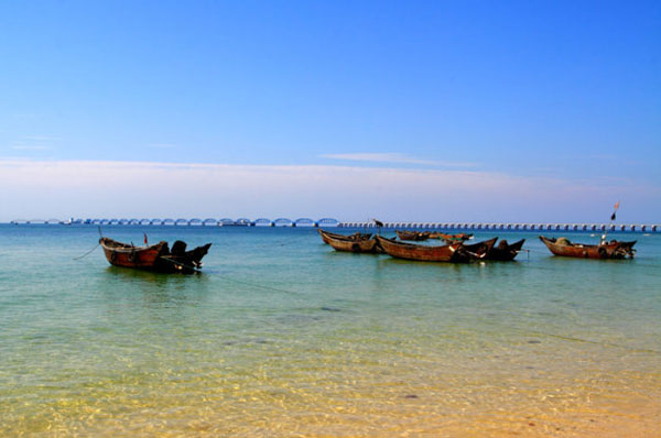 Boats anchored in the shallow beach water on Weizhou Island.