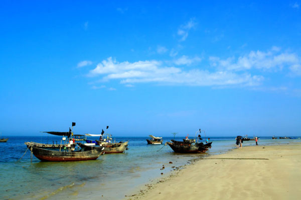 The beach on Weizhou Island is sparsely populated by tourists.