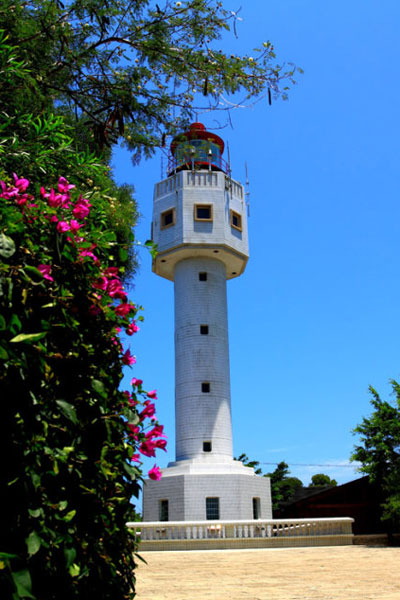 A white lighthouse watches over people at sea on Weizhou Island. 