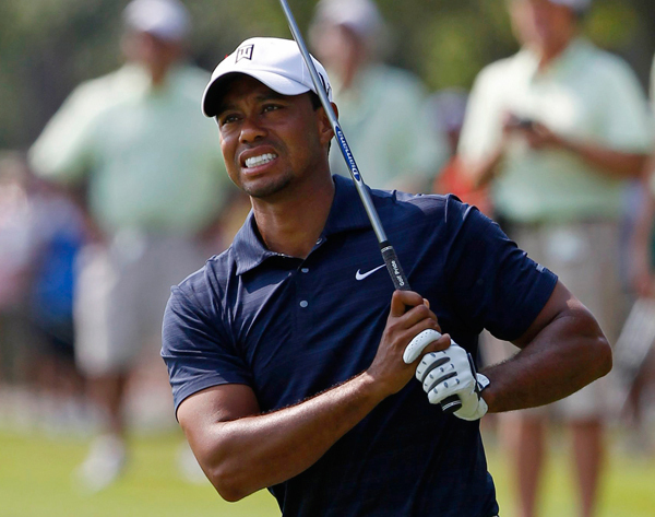 Tiger Woods of the U.S. reacts after hitting his second shot on the ninth hole during first round play of The Players Championship golf tournament at TPC Sawgrass in Ponte Vedra Beach, Florida May 12, 2011. (Xinhua/Reuters File Photo)