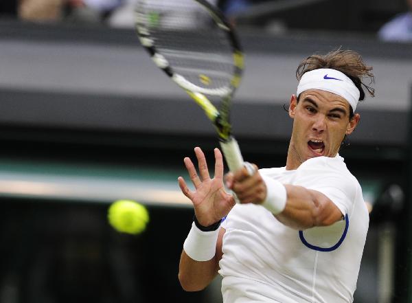 Rafael Nadal returns a shot during his 2nd round match against Ryan Sweeting of the United States at the 2011 Wimbledon tennis championships in London, Britain, June 22, 2011. Rafael Nadal won 6-3, 6-2, 6-4. (Xinhua/Zeng Yi)