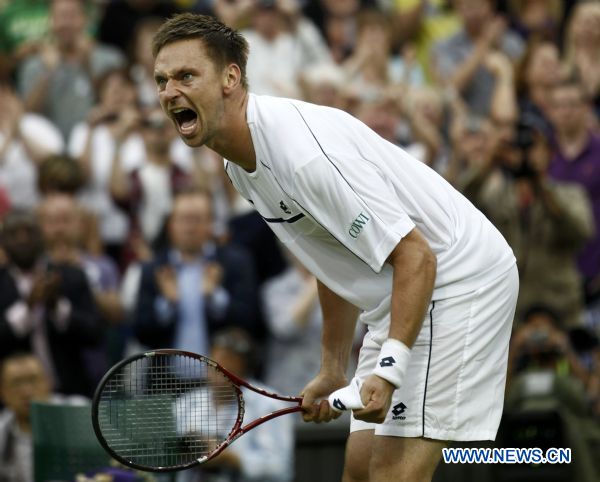 Robin Soderling of Sweden celebrates defeating Lleyton Hewitt of Australia at the Wimbledon tennis championships in London June 23, 2011. (Xinhua/Reuters) 