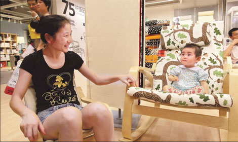 An 18-month-old child and his mother arrive at the newly opened Ikea store in the Pudong New Area, Shanghai. The Swedish retail giant has been operating in the Chinese market for more than a decade. [China Daily]