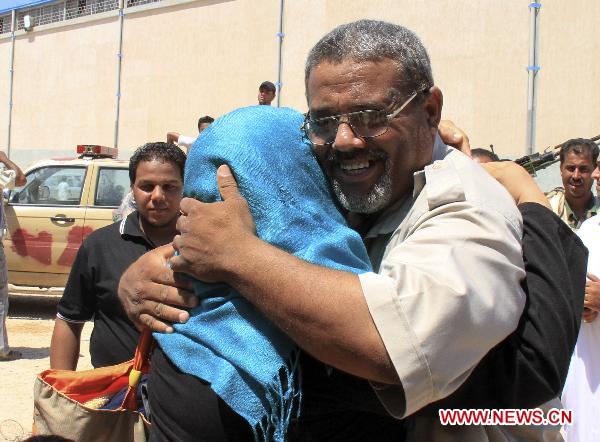 Reunited brother and sister embrace each other after International Red Cross ship the Ionis arrives to the rebel port of Benghazi, Libya, June 24, 2011. Over 300 people arrived Friday in Benghazi by the boat from Tripoli. (Xinhua/Li Zhen) 