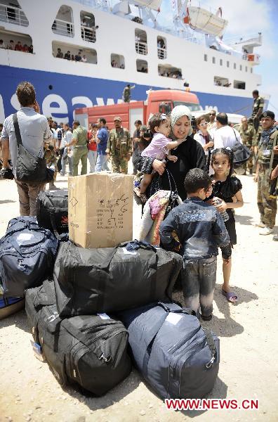 A Libyan mother waits for her families with her children after International Red Cross ship the Ionis arrives to the rebel port of Benghazi, Libya, June 24, 2011. [Xinhua/Dai Xuming] 