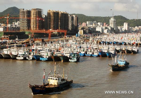 Thousands of fishing boats anchor in a safe harbour in Zhoushan, east China's Zhejiang Province, June 24, 2011. Fishermen in east China's Zhoushan have been taking precaution against Meari, a tropical storm which is about to hit the region Saturday afternoon. Surrounded by the East China Sea, Zhoushan is a major fishery center in China. [Xinhua/Hu Sheyou]