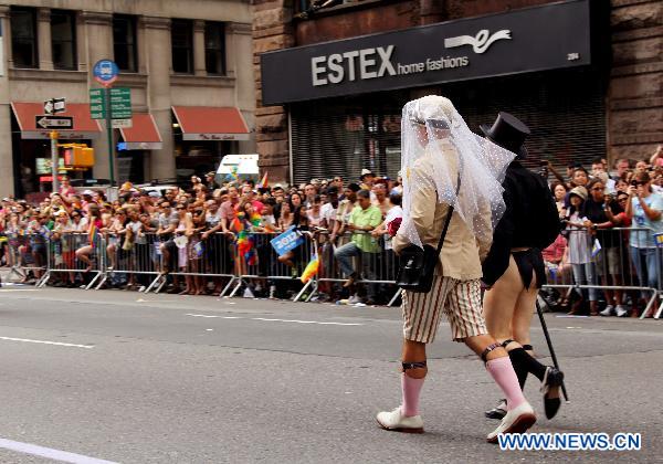 Participants take part in the NYC Gay Pride Parade along the Fifth Avenue in Manhattan, New York City, June 26, 2011. New York State lawmakers voted late Friday to legalize same-sex marriage, making New York the sixth and most populous U.S. state to allow gay marriage.[Wu Jingdan/Xinhua]