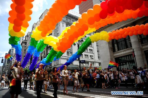 Participants take part in the NYC Gay Pride Parade along the Fifth Avenue in Manhattan, New York City, June 26, 2011. New York State lawmakers voted late Friday to legalize same-sex marriage, making New York the sixth and most populous U.S. state to allow gay marriage.[Wu Jingdan/Xinhua] 