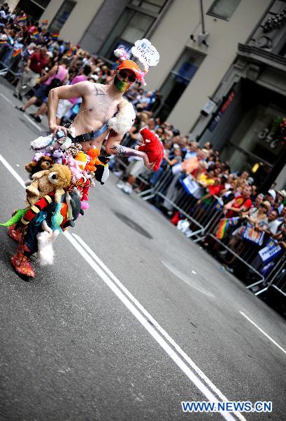 A participant takes part in the NYC Gay Pride Parade along the Fifth Avenue in Manhattan, New York City, June 26, 2011. New York State lawmakers voted late Friday to legalize same-sex marriage, making New York the sixth and most populous U.S. state to allow gay marriage. [Shen Hong/Xinhua]