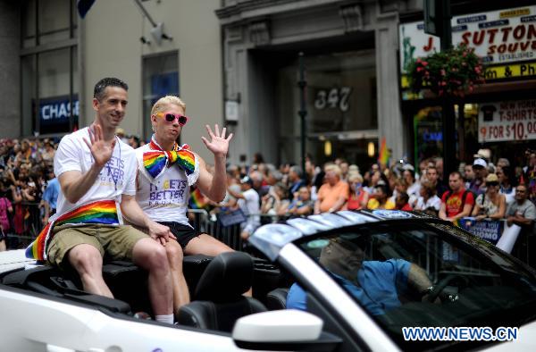 Participants take part in the NYC Gay Pride Parade along the Fifth Avenue in Manhattan, New York City, June 26, 2011. New York State lawmakers voted late Friday to legalize same-sex marriage, making New York the sixth and most populous U.S. state to allow gay marriage.[Shen Hong/Xinhua]