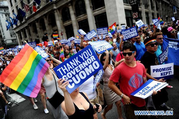 Participants take part in the NYC Gay Pride Parade along the Fifth Avenue in Manhattan, New York City, June 26, 2011. New York State lawmakers voted late Friday to legalize same-sex marriage, making New York the sixth and most populous U.S. state to allow gay marriage.[Shen Hong/Xinhua]