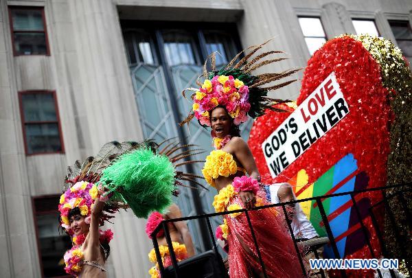 Participants take part in the NYC Gay Pride Parade along the Fifth Avenue in Manhattan, New York City, June 26, 2011. New York State lawmakers voted late Friday to legalize same-sex marriage, making New York the sixth and most populous U.S. state to allow gay marriage.[Shen Hong/Xinhua]