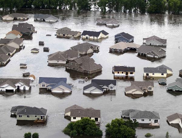 Newer houses on the southwest side of Minot, North Dakota, are seen submerged in flood waters June 25, 2011. The rapidly rising Souris River poured over flood defenses in North Dakota, overwhelming efforts to delay the deluge and forcing the immediate evacuation of thousands of homes. Flood projections have forecasted about 18 more inches of water before levels begin dropping.