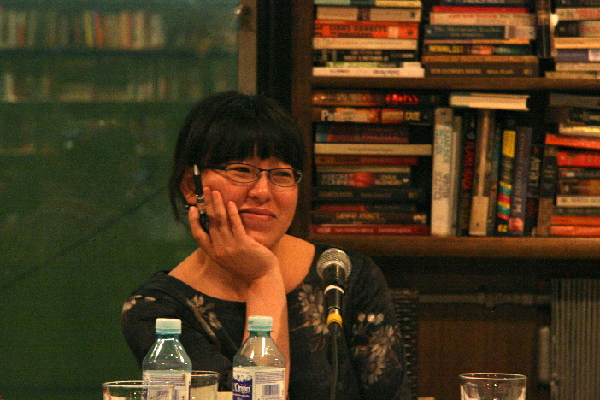 An Dun, author of 'The Chinese Dream Series,'smiles as her stories are translated to the crowd gathering at the launch of her third book. The book chronicles the dreams of migrant workers in urban areas of China.