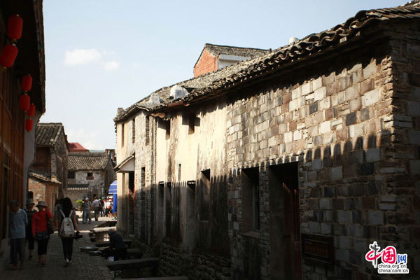 Visitors walk through the maze of the township's narrow lanes.