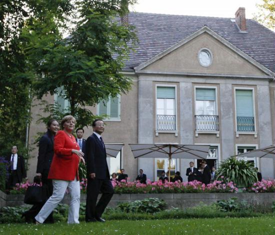 German Chancellor Angela Merkel (L) and Premier Wen Jiabao walk in the park of Villa Liebermann at the Wannsee lake before a dinner in Berlin, June 27, 2011.