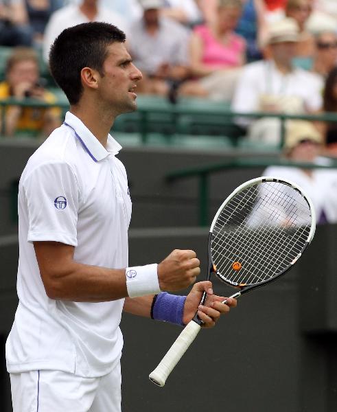 Novak Djokovic of Serbia celebrates a point during his fourth round match against Michael Llodra of France in 2011's Wimbledon Championships in London, Britain, June 27, 2011. Djokovic won 3-0. (Xinhua/Tang Shi)(hcs) 
