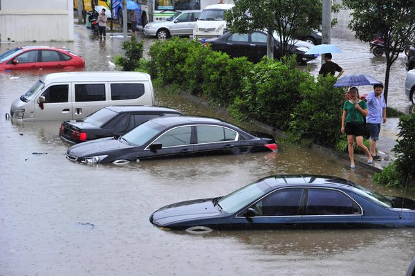 Cars are submerged in floodwaters on a street in Changsha, the capital of Central China&apos;s Hunan province, June 28, 2011. [CFP] 