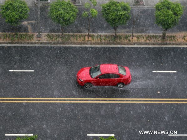 A car runs on the highway as downpour hit Jinjiang City of southeast China&apos;s Fujian Province, June 28, 2011. Heavy rainfall seriously disturbed the city&apos;s traffic.