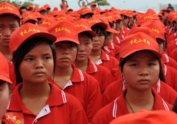 Students take part in the launching ceremony of 'Re-experience of Deng Xiaoping's Road' in front of the Baise Revolt Memorial Hall in South China's Guangxi Zhuang autonomous region on June 28, 2011. 