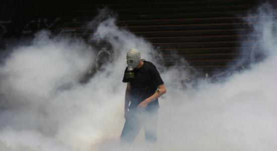 A demonstrator is surrounded by teargas during protests against austerity measures in Athens, June 28, 2011.