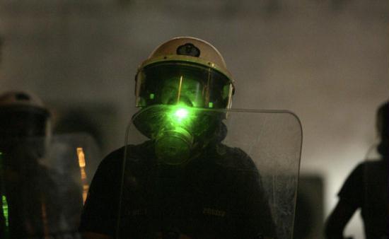 A policeman is pointed with a laser beam operated by protesters during a rally against austerity measures in Athens' Constitution (Syntagma) square June 28, 2011.