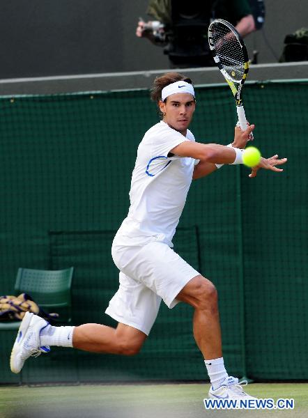Rafael Nadal of Spain returns a shot during his quarterfinal match against Mardy Fish of the United States in 2011's Wimbledon Championships in London, Britain, June 29, 2011. Nadal won 3-1 to enter the semifinals. (Xinhua/Zeng Yi) 